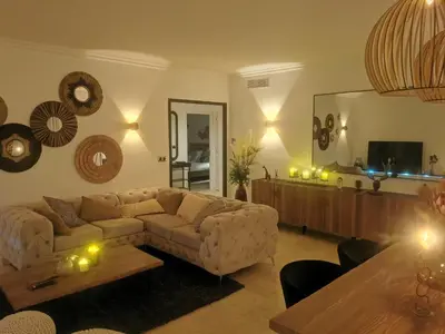 a living room with a couch and a table at 2 bedrooms seafront in Cannes