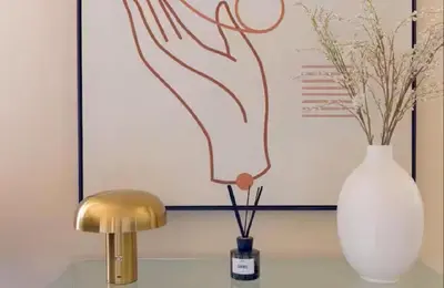 a white vase sitting next to a gold lamp at LE ROCHER avec terrasse et vue mer, près du centre-ville in Cannes