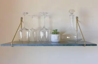 four glass vases and a potted plant on a shelf at LE ROCHER avec terrasse et vue mer, près du centre-ville in Cannes