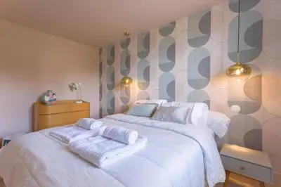 a bedroom with a white bed with towels on it at LE ROCHER avec terrasse et vue mer, près du centre-ville in Cannes