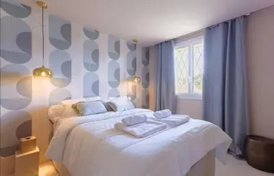 a bedroom with a bed with towels on it at LE ROCHER avec terrasse et vue mer, près du centre-ville in Cannes