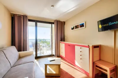 a living room with a couch and a large window at Résidence Cannes Villa Francia - maeva Home - Appartement 2 pièces 4 personnes - Sélection MAE-3514 in Cannes