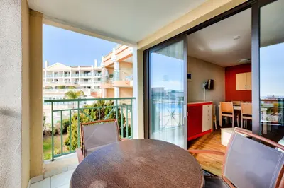 a table and chairs in a room with a balcony at Résidence Cannes Villa Francia - maeva Home - Appartement 2 pièces 4 personnes - Sélection MAE-3514 in Cannes