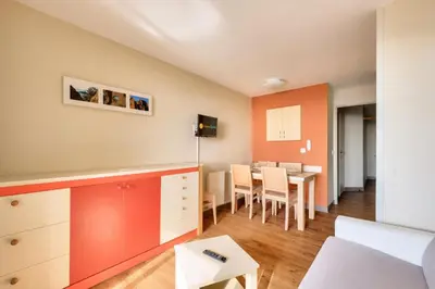 a living room with a table and a dining room at Résidence Cannes Villa Francia - maeva Home - Appartement 2 pièces 4 personnes - Sélection MAE-3514 in Cannes