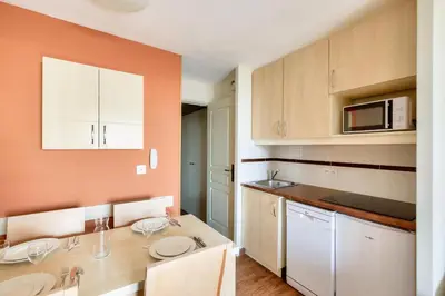 a kitchen with two sinks and a microwave at Résidence Cannes Villa Francia - maeva Home - Appartement 2 pièces 4 personnes - Sélection MAE-3514 in Cannes