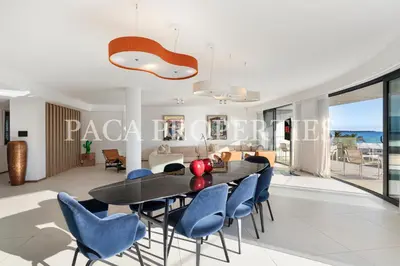 a dining room with a table and blue chairs at Paca Properties -401- 5 Chambres Luxe in Cannes