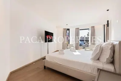 a white bedroom with a large bed and a window at Paca Properties -401- 5 Chambres Luxe in Cannes