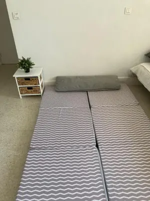 a large mattress in a room with a bed at Studio à 10 min de la croisette et de la mer et 5 min de la gare in Cannes