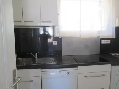a kitchen with a sink and a stove at Studio à 10 min de la croisette et de la mer et 5 min de la gare in Cannes
