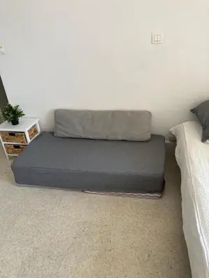 a bed sitting in a room next to two beds at Studio à 10 min de la croisette et de la mer et 5 min de la gare in Cannes