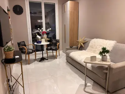 a living room with a couch and a table with chairs at Boulevard de la croisette PALAIS MIRAMAR in Cannes