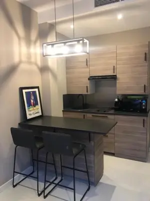 a kitchen with a table and chairs in a room at Boulevard de la croisette PALAIS MIRAMAR in Cannes