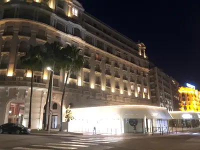 a large white building with a lit up facade at night at Boulevard de la croisette PALAIS MIRAMAR in Cannes