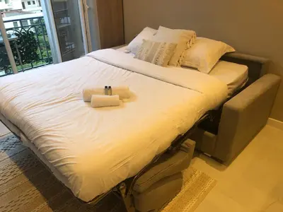 a large bed with two towels on top of it at Boulevard de la croisette PALAIS MIRAMAR in Cannes