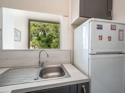 a kitchen with a sink and a refrigerator at Apartment Val Joli-1 by Interhome in Cannes