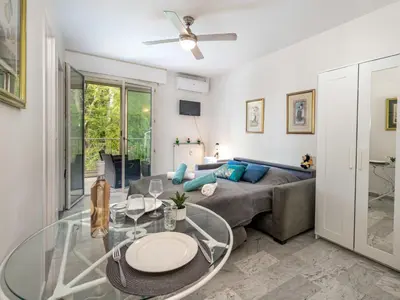 a living room with a couch and a glass table at Apartment Val Joli-1 by Interhome in Cannes