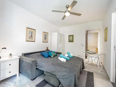 a bedroom with a large bed with blue pillows at Apartment Val Joli-1 by Interhome in Cannes