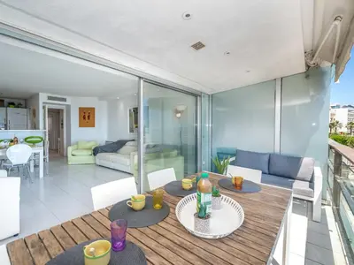 a room with two tables and a living room at Apartment Cannes Bay-3 by Interhome in Cannes