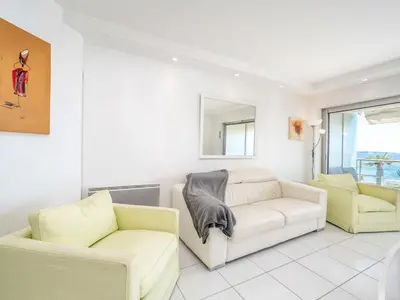 a living room with two chairs and a couch at Apartment Cannes Bay-3 by Interhome in Cannes