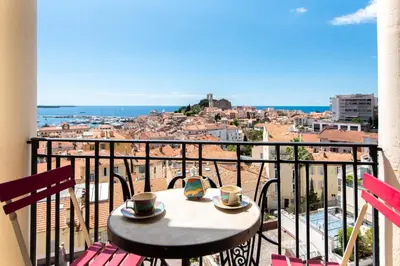 a table and chairs on a balcony with a view at LE SINATRA splendide vue mer panoramique et balcon, idéal pour des séjours de loisirs ou business in Cannes