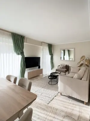 a living room with a couch and a table at Cosy stay - LA CROISETTE in Cannes