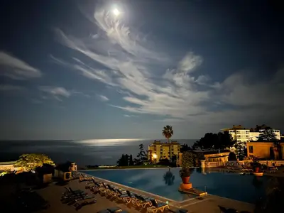 a view of a swimming pool at night at EXCEPTIONNEL sur CANNES vue mer piscine in Cannes