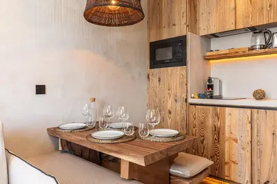 a wooden table with wine glasses on top of it at WABISABI SUITES - BRAILLE in Cannes