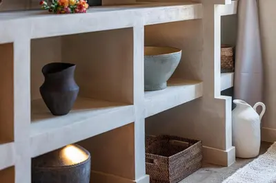 a shelf with vases and baskets in a room at WABISABI SUITES - BRAILLE in Cannes