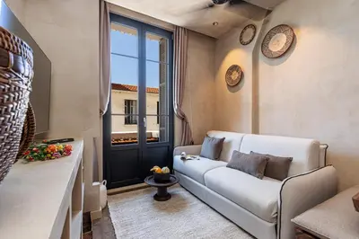 a living room with a couch and a window at WABISABI SUITES - BRAILLE in Cannes