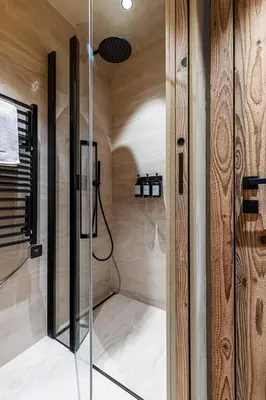 a shower with a glass door in a bathroom at WABISABI SUITES - BRAILLE in Cannes