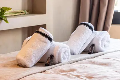 a group of rolled up towels on a bed at WABISABI SUITES - BRAILLE in Cannes