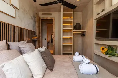a living room with a couch and some towels at WABISABI SUITES - BRAILLE in Cannes