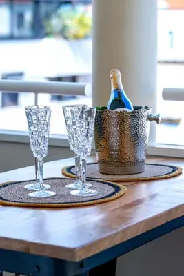 a table with two glasses and a bottle of wine at Renovated bijou gem in heart of Cannes in Cannes
