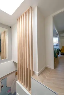 a room with a wooden partition with a mirror at Renovated bijou gem in heart of Cannes in Cannes