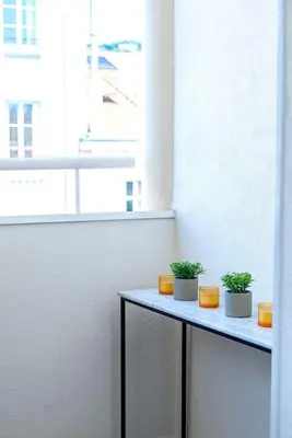two plants sitting on a table in a room at Renovated bijou gem in heart of Cannes in Cannes