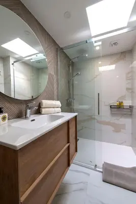 a bathroom with a sink and a shower with a mirror at Renovated bijou gem in heart of Cannes in Cannes