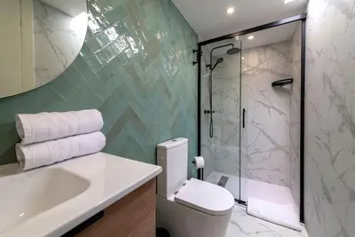a bathroom with a toilet and a sink and a shower at Renovated bijou gem in heart of Cannes in Cannes