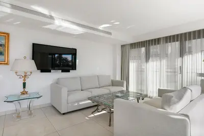 a living room with a couch and a table at PACA Properties 7C2 - appartement 3 chambres in Cannes