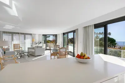 a white kitchen with a bowl of fruit on a counter at PACA Properties 7C2 - appartement 3 chambres in Cannes