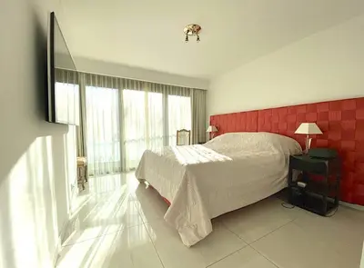 a bedroom with a bed and a red wall at PACA Properties 7C2 - appartement 3 chambres in Cannes