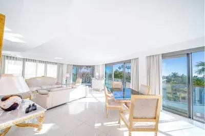 a living room with a couch and chairs and windows at PACA Properties 7C2 - appartement 3 chambres in Cannes