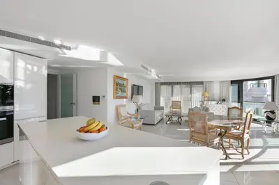 a kitchen and living room with a bowl of fruit on a counter at PACA Properties 7C2 - appartement 3 chambres in Cannes