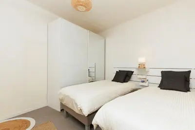 two beds in a bedroom with white walls at Cannes: Croisette Quartier Martinez - 90m² in Cannes