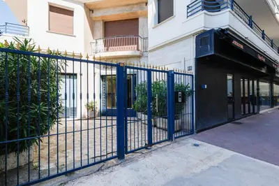a blue fence in front of a building at Cannes: Croisette Quartier Martinez - 90m² in Cannes