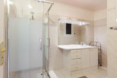 a bathroom with a sink and a shower at Cannes: Croisette Quartier Martinez - 90m² in Cannes