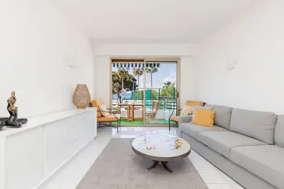 a living room with a couch and a table at Cannes: Croisette Quartier Martinez - 90m² in Cannes