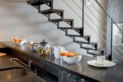 a kitchen counter with a sink and a staircase at Alma Gallia 4 pers in Cannes