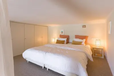 a bedroom with a large white bed with two lamps at Alma Gallia 4 pers in Cannes