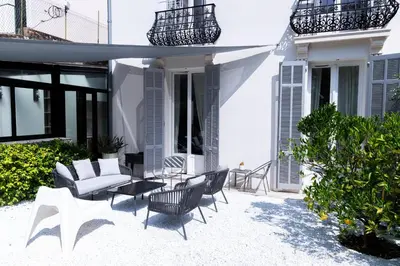 a bathroom with a white sink and a mirror at Sweett - Hotel Particulier Garden in Cannes