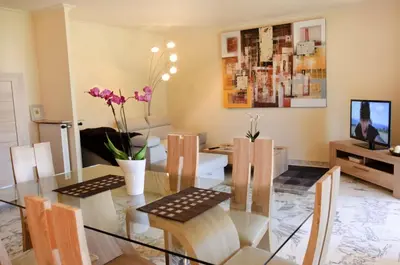 a dining room with a glass table and chairs at 90m2 Apartement - Les Palmiers de Cannes in Cannes